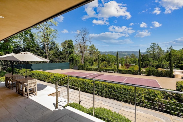 view of tennis court featuring a mountain view