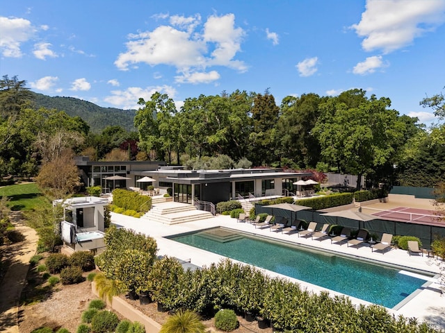 view of swimming pool with a fenced in pool, a diving board, and a patio
