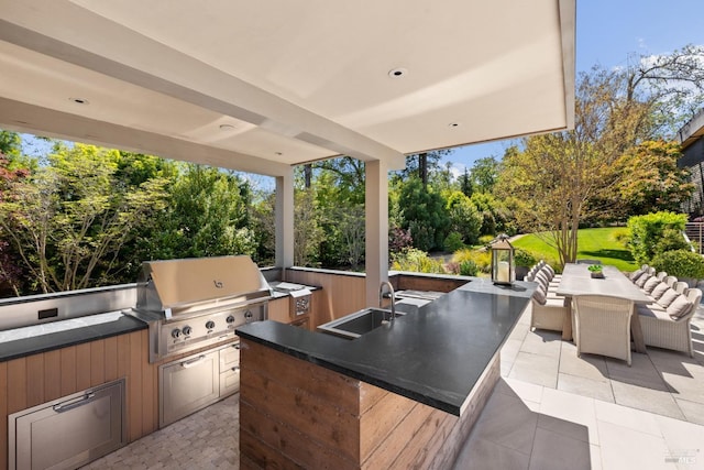 view of patio / terrace featuring grilling area, a sink, area for grilling, and outdoor dining area
