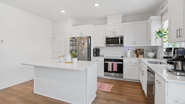 kitchen featuring light countertops, a sink, white cabinetry, and appliances with stainless steel finishes