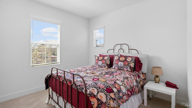 bedroom with baseboards and carpet