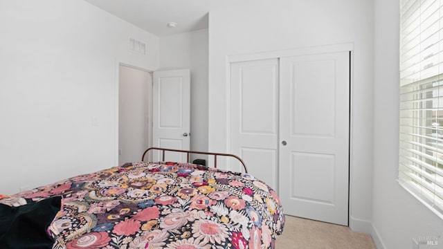 bedroom featuring carpet, a closet, and visible vents