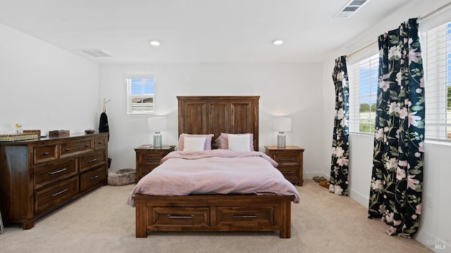bedroom with light colored carpet, visible vents, and recessed lighting