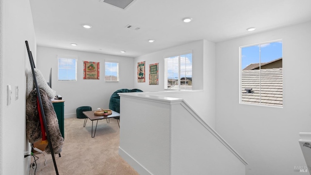 laundry area with light colored carpet, a wealth of natural light, visible vents, and recessed lighting