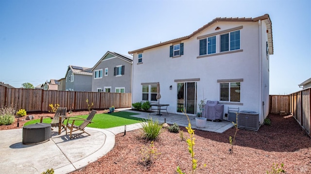 back of property with a patio, a fenced backyard, an outdoor fire pit, and stucco siding