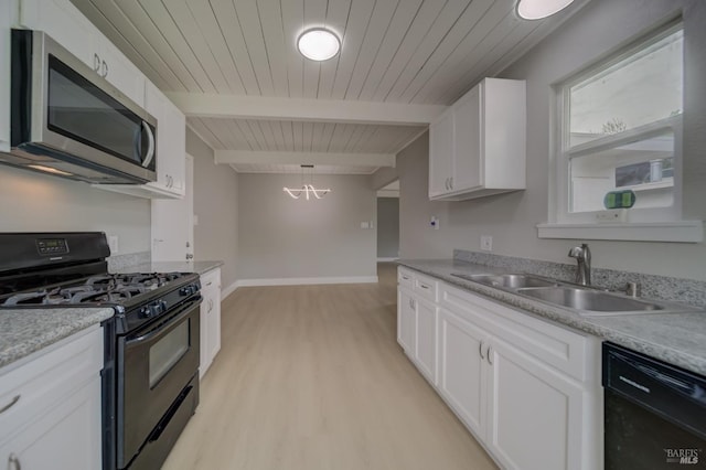 kitchen with white cabinets, a sink, light wood-style floors, a chandelier, and black appliances