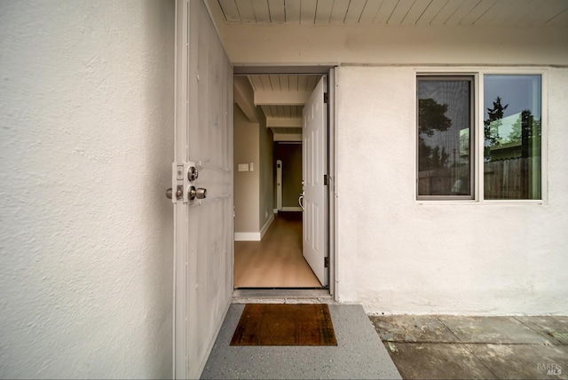 entrance to property featuring stucco siding