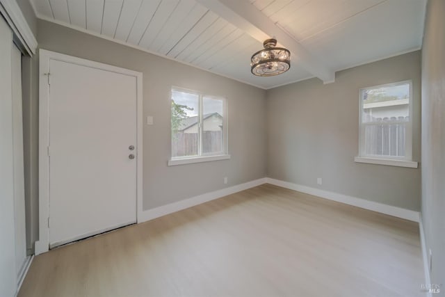 interior space featuring baseboards, plenty of natural light, and wood finished floors