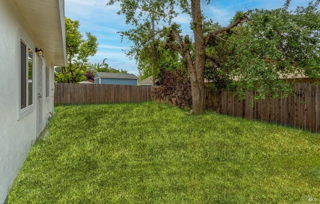 view of yard with a fenced backyard