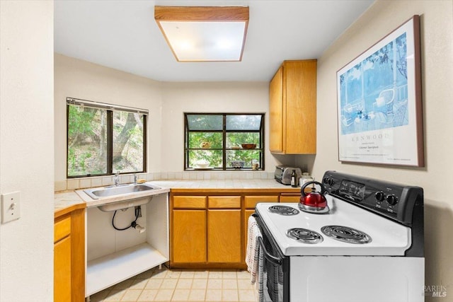 2426 S Fitch Mountain Rd, Healdsburg, CA 95448 - kitchen with brown cabinetry, tile counters, white range with electric stovetop, and a sink
