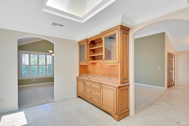 581 Werner Way, Vacaville, CA 95688 - hallway with light colored carpet, ornamental molding, light tile patterned floors, baseboards, and arched walkways