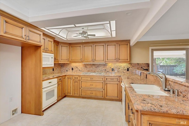 581 Werner Way, Vacaville, CA 95688 - kitchen with a sink, white appliances, tasteful backsplash, light stone counters, and a peninsula