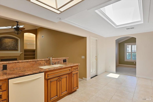 581 Werner Way, Vacaville, CA 95688 - kitchen featuring a sink, white dishwasher, arched walkways, brown cabinetry, and a ceiling fan
