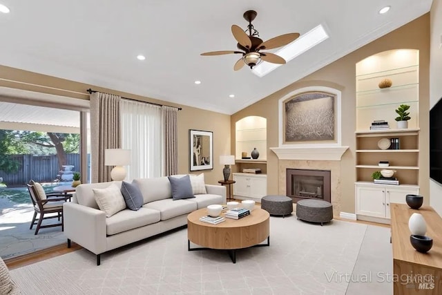 581 Werner Way, Vacaville, CA 95688 - living area featuring lofted ceiling, built in features, a ceiling fan, a glass covered fireplace, and recessed lighting