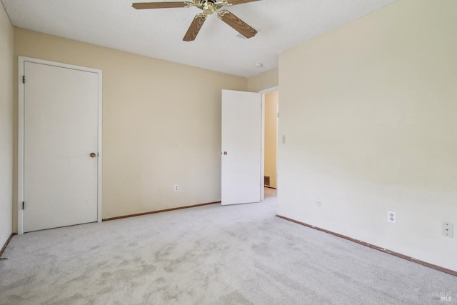 interior space with baseboards, carpet, and ceiling fan
