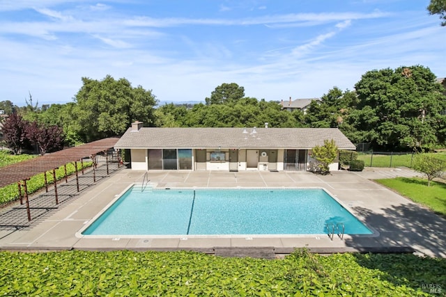 community pool with fence and a patio area
