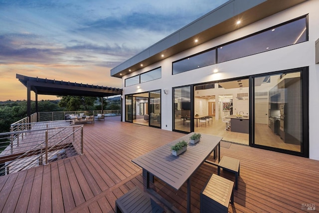 deck with outdoor dining area and a sink
