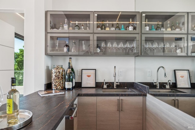 bar featuring wet bar and a sink