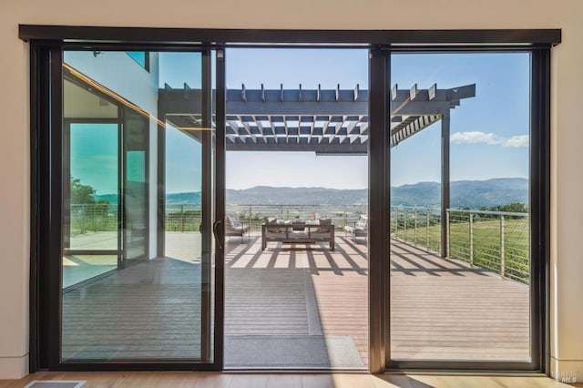 doorway to outside featuring a mountain view and wood finished floors