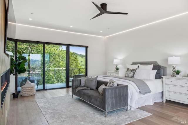 bedroom with wood-type flooring and a ceiling fan