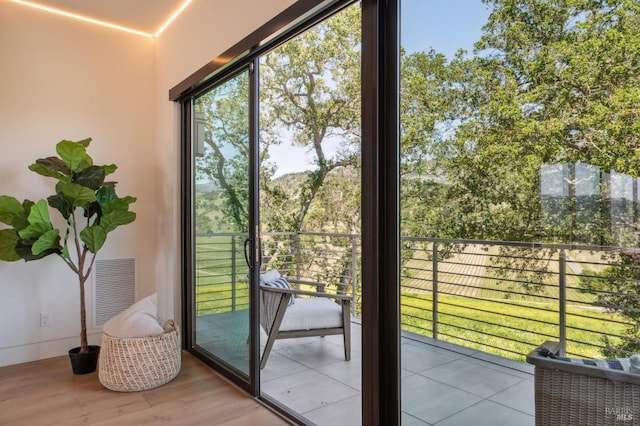 doorway featuring visible vents, wood finished floors, and a wealth of natural light
