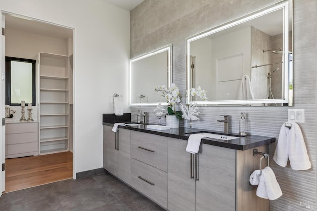 bathroom with baseboards, a sink, and backsplash