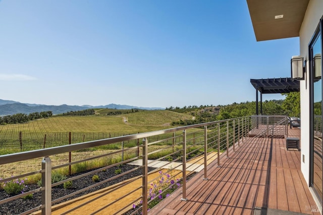 wooden terrace featuring a mountain view and a rural view