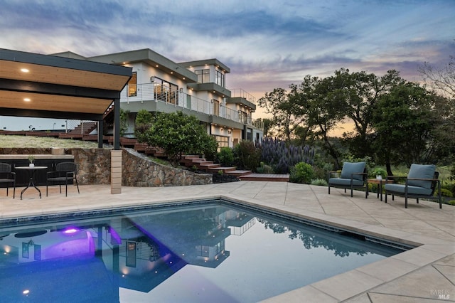 pool featuring stairs and a patio area