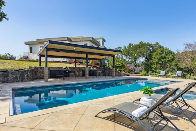 pool featuring stairway, a patio, a gazebo, and outdoor dry bar