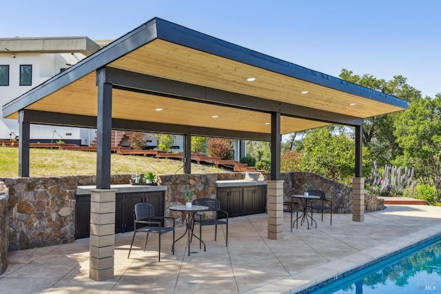 view of patio with a gazebo and an outdoor pool