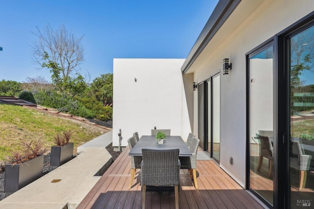 wooden deck with outdoor dining area