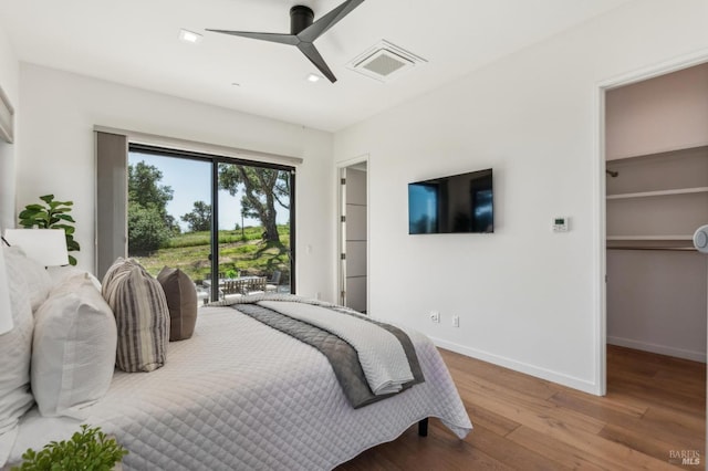 bedroom featuring visible vents, wood finished floors, recessed lighting, access to outside, and a spacious closet