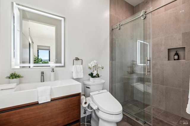 full bath featuring vanity, a stall shower, and toilet