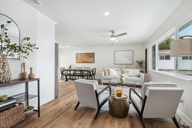 living area with ceiling fan, light wood finished floors, and recessed lighting