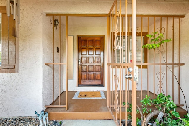 property entrance with stucco siding