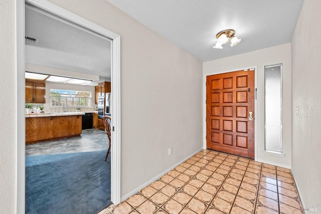 entrance foyer with visible vents and baseboards