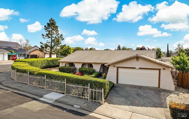 single story home with driveway, a tiled roof, fence private yard, a garage, and stucco siding