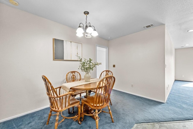 dining room with an inviting chandelier, carpet floors, visible vents, and baseboards