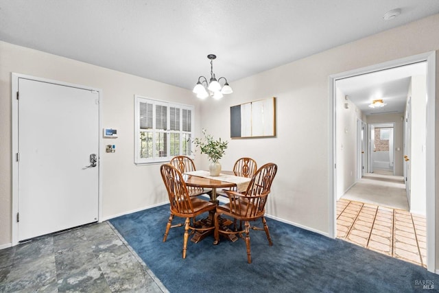 dining room with baseboards and an inviting chandelier