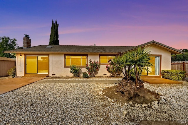 ranch-style house featuring stucco siding, fence, a chimney, and crawl space