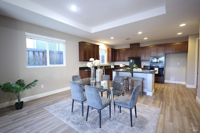 dining space with light wood-style flooring, baseboards, and recessed lighting