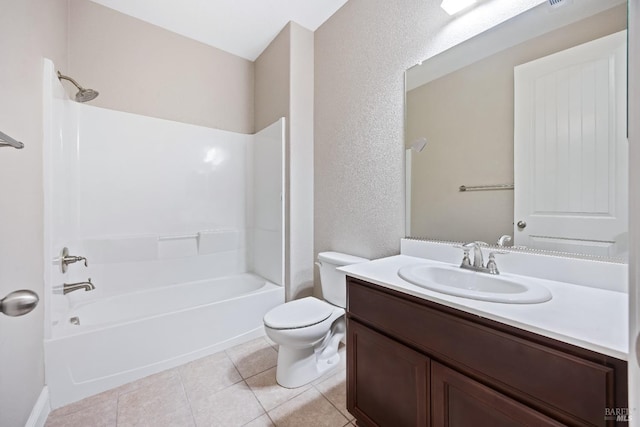 full bath featuring tile patterned flooring, shower / washtub combination, a textured wall, toilet, and vanity