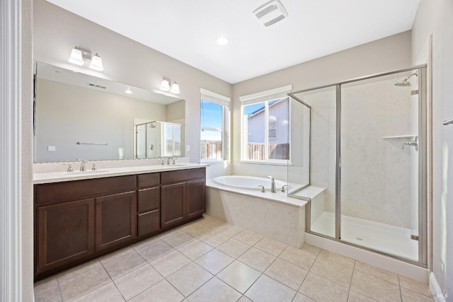 full bath with a shower stall, tile patterned floors, and a sink