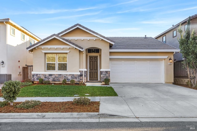 view of front facade featuring an attached garage, stone siding, a tile roof, and driveway