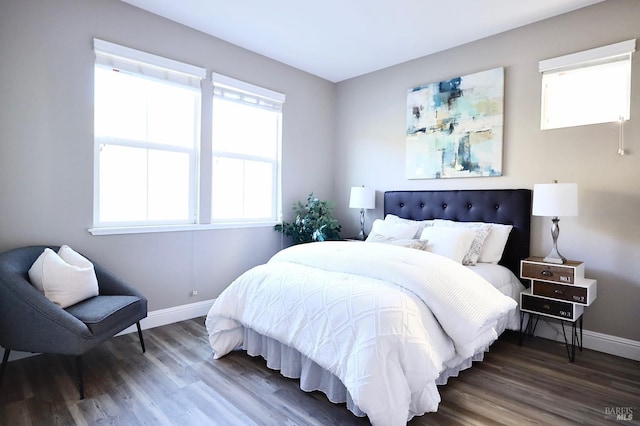 bedroom with wood finished floors and baseboards