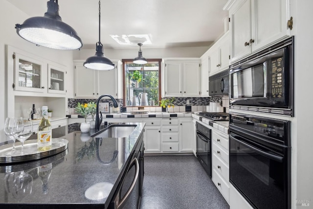 kitchen featuring black appliances, decorative backsplash, a sink, and white cabinets