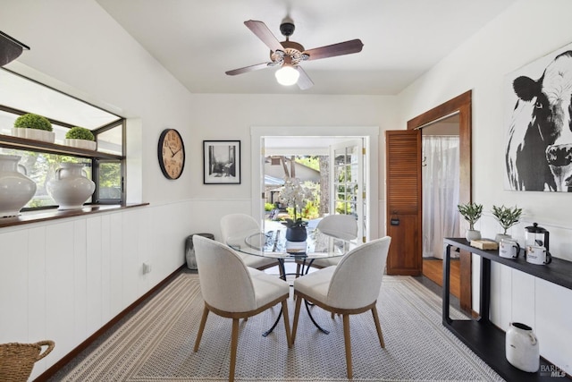 dining room with wainscoting, ceiling fan, and a wealth of natural light