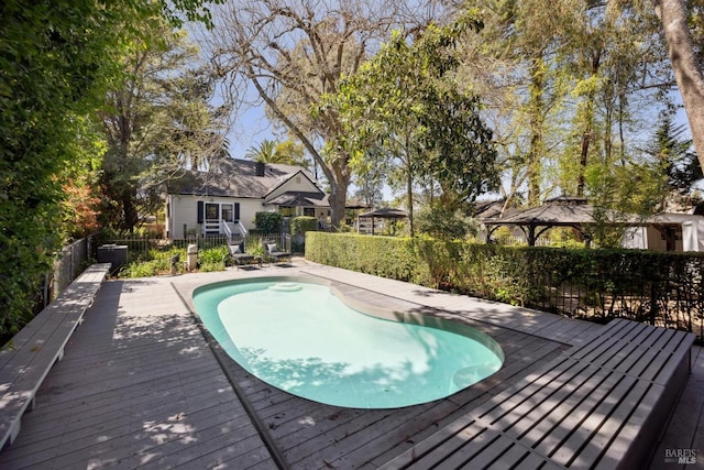 view of swimming pool with a fenced in pool, fence private yard, a gazebo, and a deck
