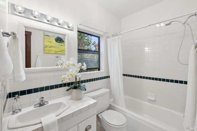 bathroom with tile walls, toilet, vanity, and shower / bath combination with curtain