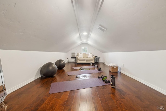 workout room featuring lofted ceiling, hardwood / wood-style flooring, and baseboards